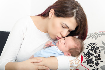 Obraz na płótnie Canvas Healthy Woman and New Born Boy Relax in White Bedroom or Living