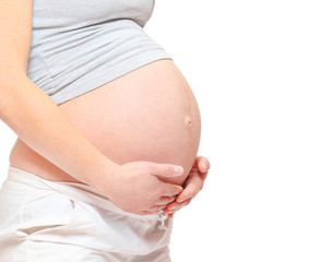 A woman's hands on pregnant belly. Body part isolated on white background. Love and new life concept. 
