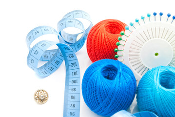 pins, button, blue meter and thread