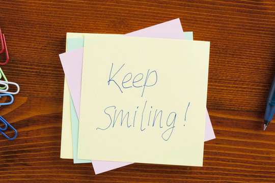 Keep smiling written on a note