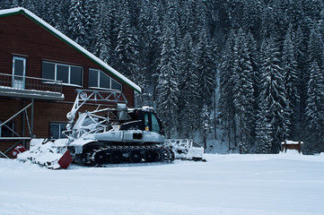 Snowcat on ski resort in snowy weather