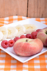 peach raspberries bananas close up as health food concept
