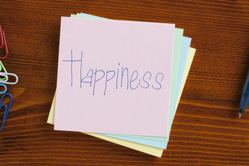 Happiness handwritten on a note