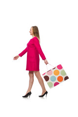 Shopper girl in pink dress holding plastic bags isolated on whit