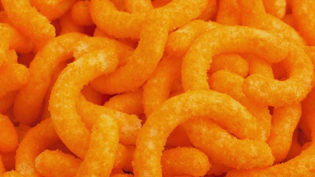 Cheese Puffs Snack Rotating Closeup