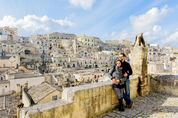 Attractive couple enjoying view of Matera old town of Southern Italy on a beautiful sunny day