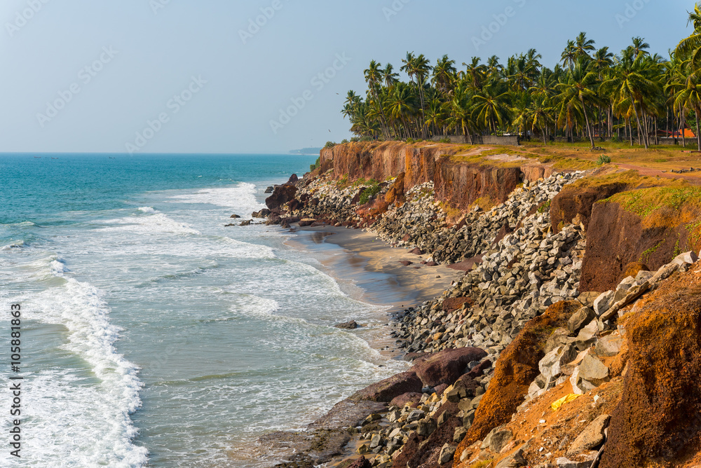 Wall mural shore protection measures in india - steep coastline strengthened with stones. coastline of edava vi