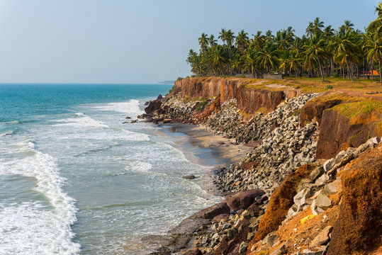 Shore protection measures in India - steep coastline strengthened with stones. Coastline of Edava village, around 2 km away to the North from resort Varkala, Kerala, India