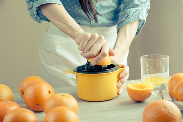 woman squeezing oranges for juice