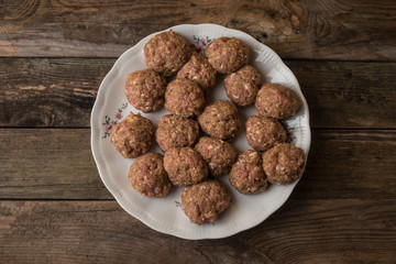 Raw meatballs on the wooden table