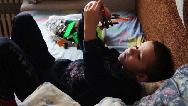 Child Boy Playing with Toys