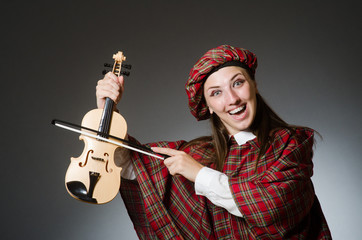 Woman in scottish clothing in musical concept