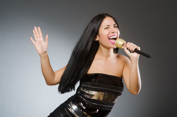 Young woman singing in karaoke club