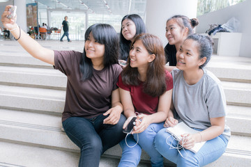 group of happy teen high school students outdoors, Asian, tutoring, Laptop, Tablet