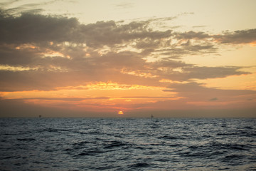 Offshore oil and rig platform in sunset or sunrise time. Construction of production process in the sea. Power energy of the world.