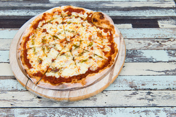 Pizza Margarita on wood background