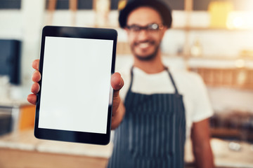 Digital tablet in hand of cafe worker
