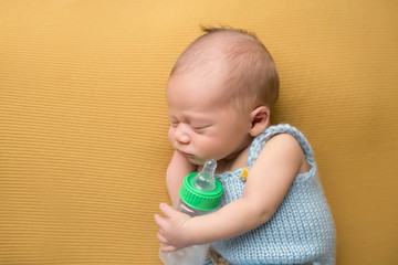Newborn Baby Sleeping with Bottle