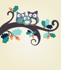 Owl family sitting on a tree branch