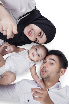 Happy Middle Eastern Family Lying In The Studio