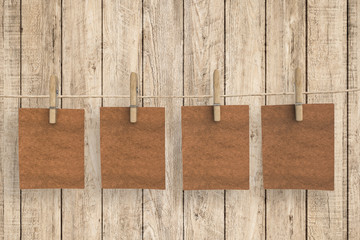 four brown blank papers on wooden background