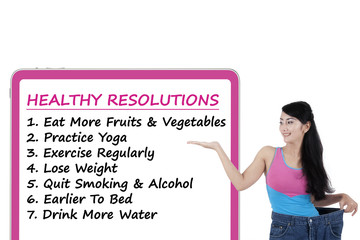 Woman shows the list of healthy resolutions
