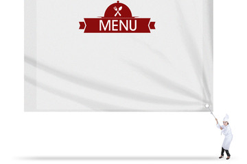 Young chef pulls a menu text on flag