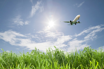 Passenger airplane landing on blue sky background