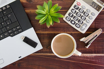 Notebook computer on the desk.Calculators,USB flash drive stick,