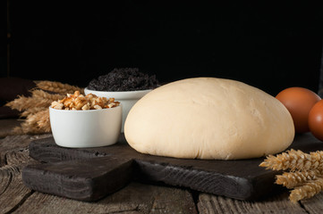 Fresh dough with ingredients to make cake or strudel