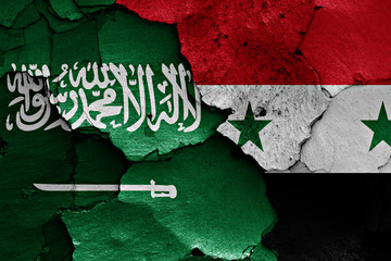 flags of Saudi Arabia and Syria painted on cracked wall - obrazy, fototapety, plakaty