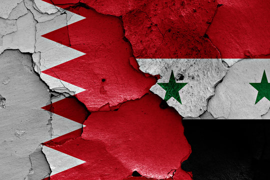 flags of Bahrain and Syria painted on cracked wall
