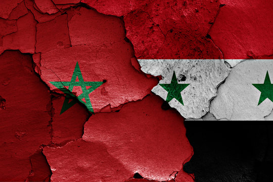 flags of Morocco and Syria painted on cracked wall