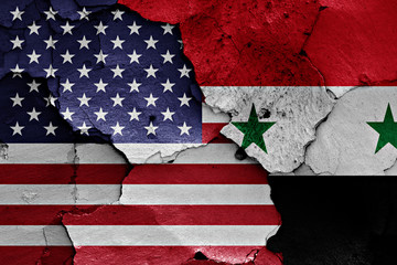 flags of USA and Syria painted on cracked wall