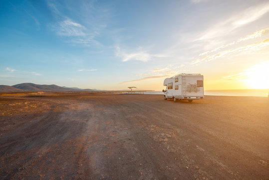 Deserted landscape with camping vehicle on Fuerteventura island in Spain. Wide angle view with copy space