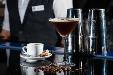 Fresh coffee cocktail with coffee beans and espresso at the bar counter in the night club.