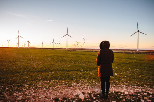 Woman watching a landscape with pinwheels