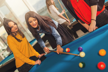 Fototapeta premium Billiards game. Group of friends playing pool together.