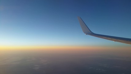 View of an aircraft wing during flight at sunset