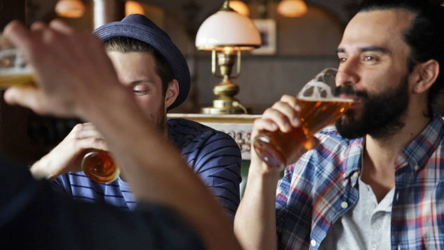 happy male friends drinking beer at bar or pub