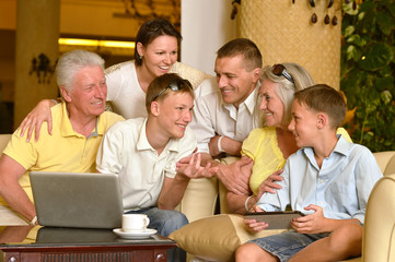 family sitting with laptop