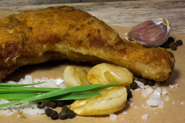 Grilled chicken drumstick on Kraft paper