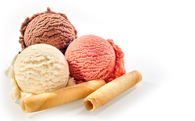 Three scoops of ice cream with wafer rolls