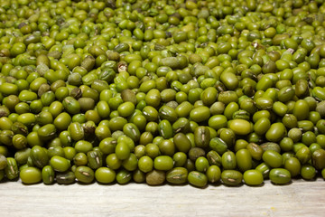 Green mung beans on a wooden background