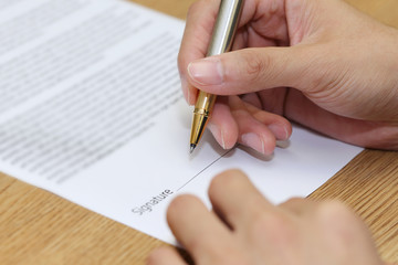 businessman hand signing a contract paper