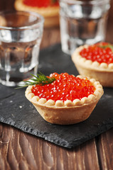 Traditional russian red caviare on the wooden table