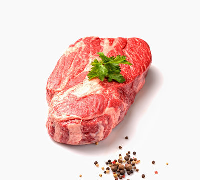 marble veal steak with parsley on a white background