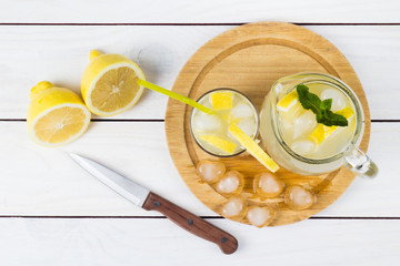 Lemon cocktail with ice and segments of a lemon