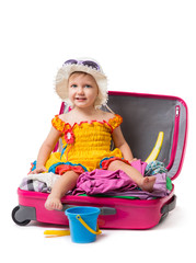 Baby sitting on a suitcase