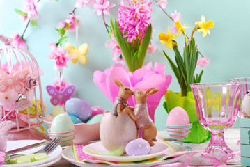 easter table decoration with rabbits and spring flowers